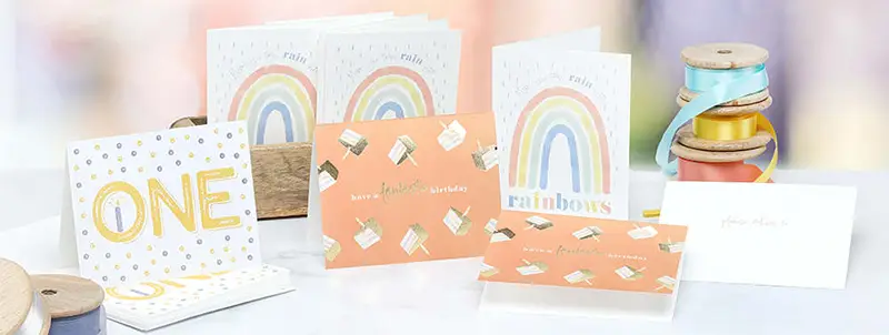 Folded A2 greeting cards featuring specialty print processes shown in a store display