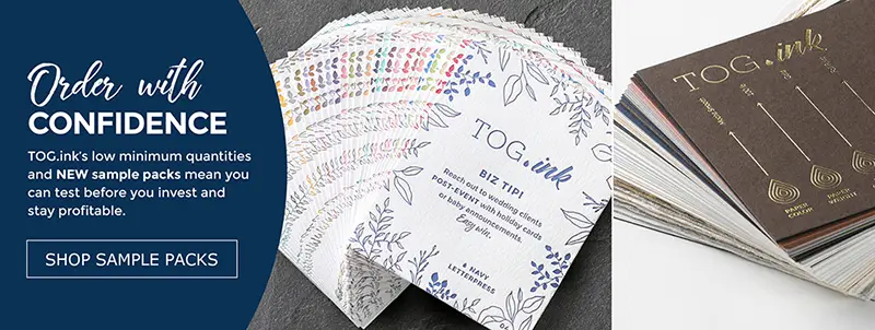 A pair of white mugs featureing custom camping designs are shown with s\mores fixing